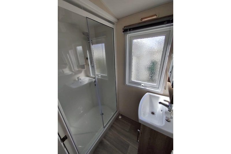 bathroom with shower, hairdryer available
