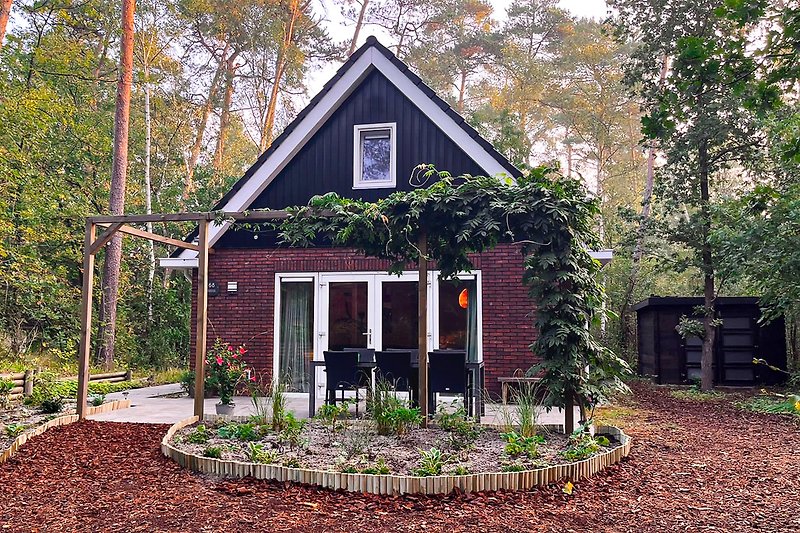 Charming cottage with lush garden and rustic facade.