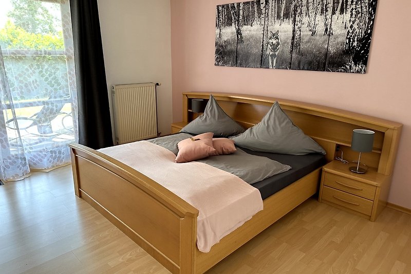 Gemütliches Schlafzimmer mit Holzmöbeln und bequemem Bett.