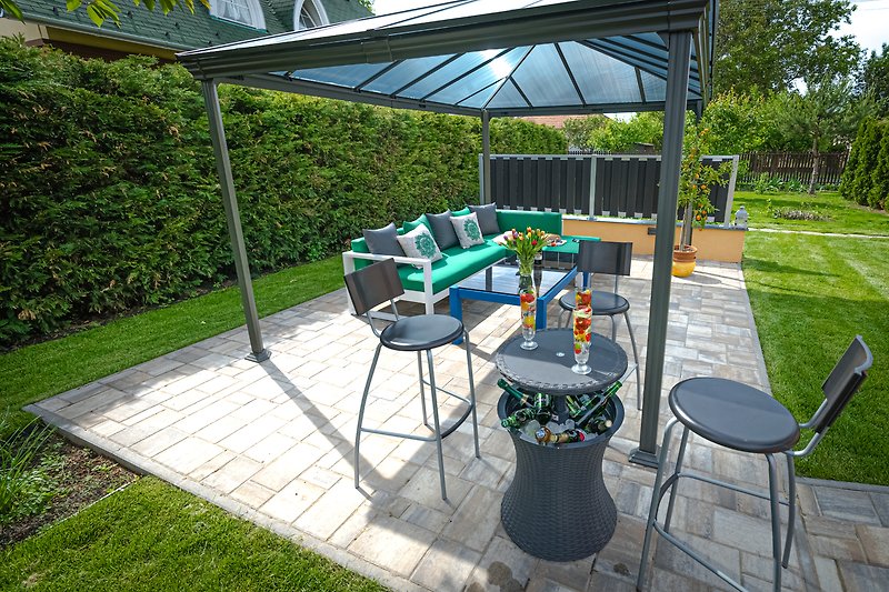 Schöne Terrasse mit stilvoller Einrichtung und grünem Tisch.