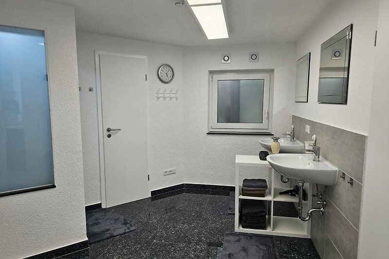 Schönes Badezimmer mit  Granitboden,  2 Waschplätzen +Spiegel . Entspannen Sie sich und genießen Sie den Komfort.