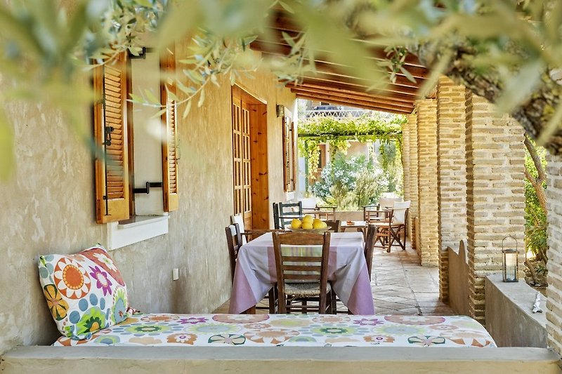 Daphnes villa no.10 has a lovely furnished veranda facing north overlooking the lush garden and oak forest.