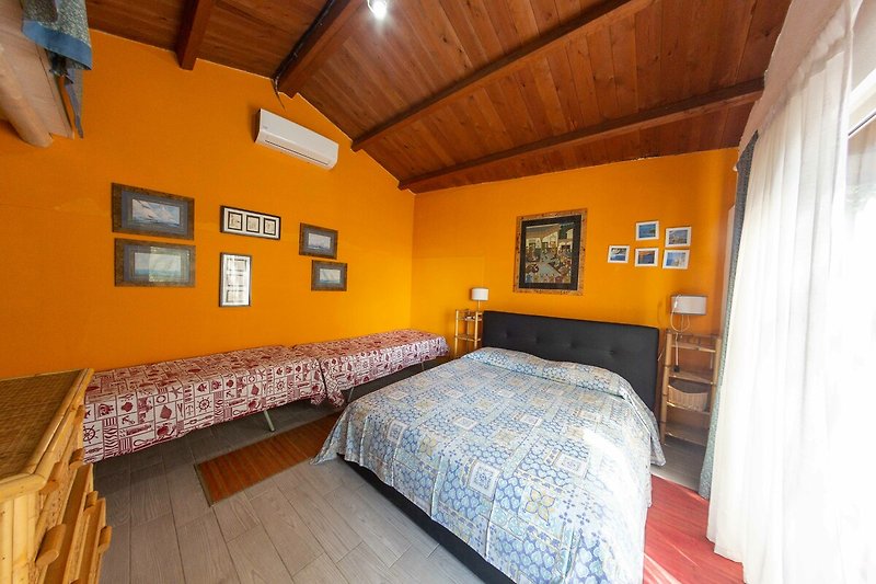 Una camera da letto accogliente con arredamento in legno e vista sulla natura. Rilassati e goditi la tua vacanza!