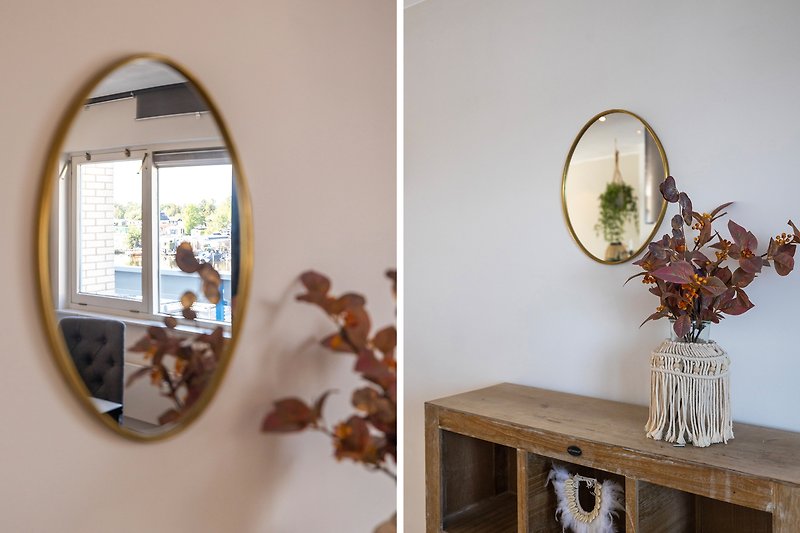 Prachtige houten meubels en stijlvolle decoratie met een spiegel en planten.