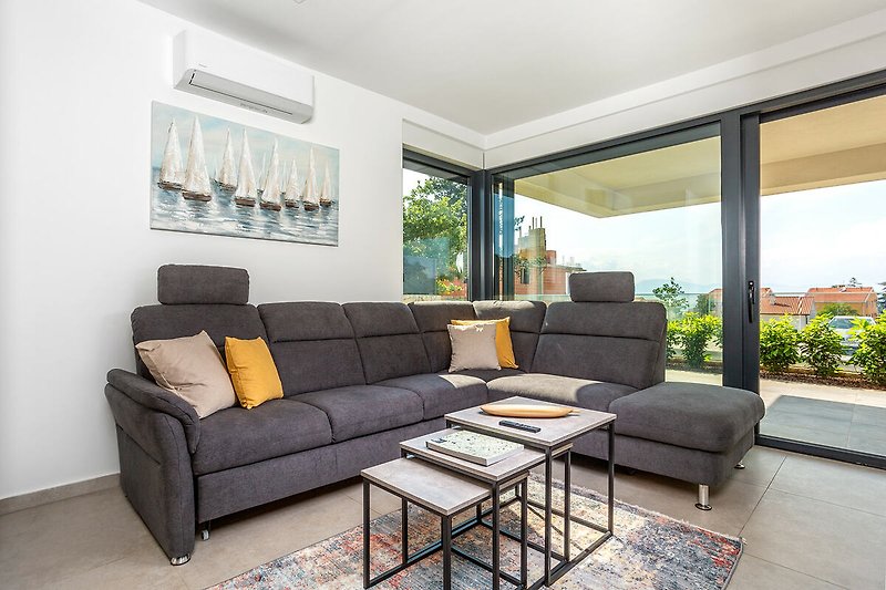 Modern villa with stylish interior, comfortable corner furniture and garden plants.
