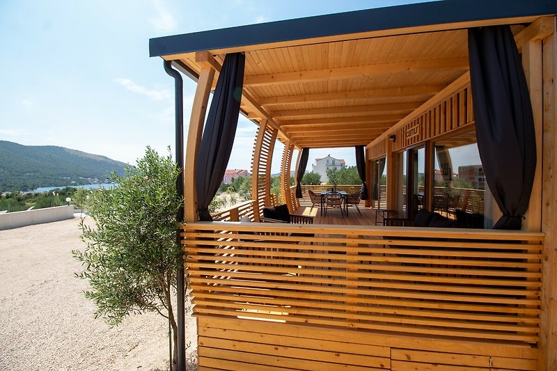 Schönes Ferienhaus mit Holzfassade und grüner Landschaft.