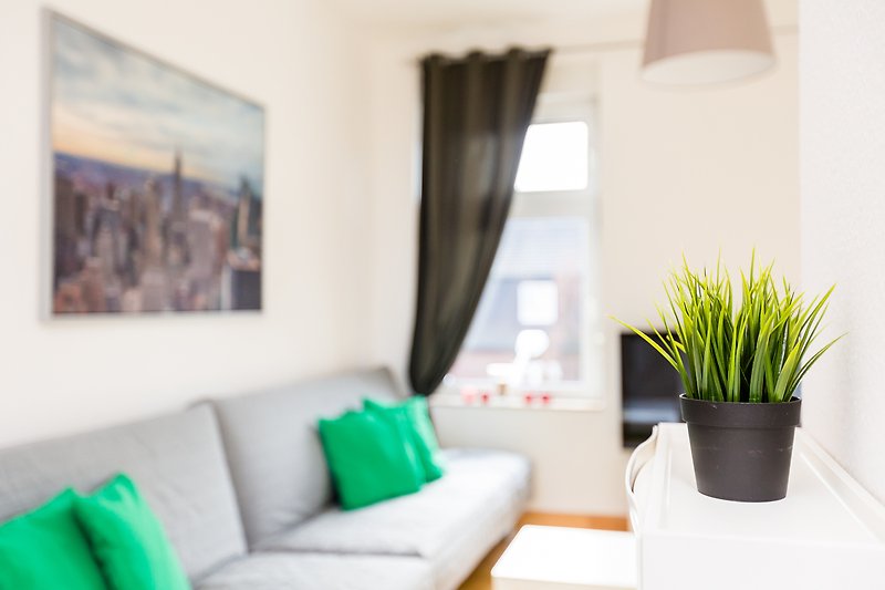 Gemütliches Wohnzimmer mit Pflanzen, bequemer Couch und stilvoller Einrichtung.
