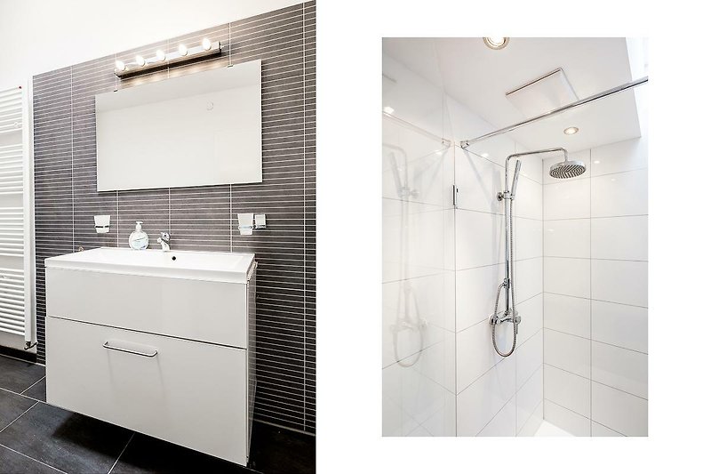 Schönes Badezimmer mit moderner Dusche, Waschbecken und Armaturen.