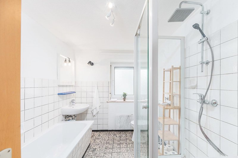 Stylish bathroom with modern fixtures and a glass shower door.