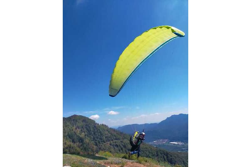 Experience the thrill of paragliding in the beautiful  mountain landscape