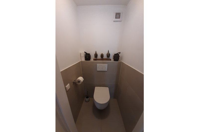 Stylish toilet with modern fixtures and elegant design.
