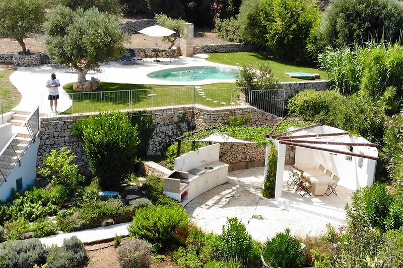Aerial view of outside kitchen/dining area and the pool terrace above.