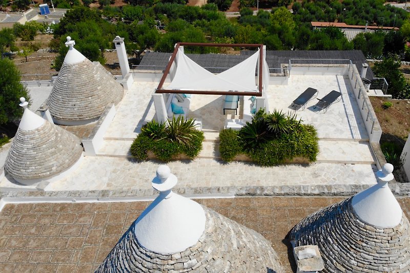 Aerial view of the outside lounge in front of the trullo