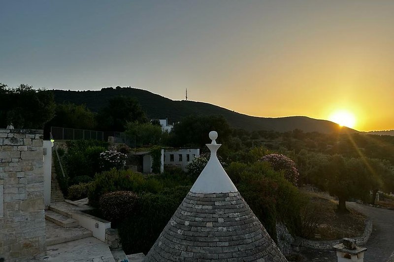 Experience a trullo with stunning mountain views and a charming garden.