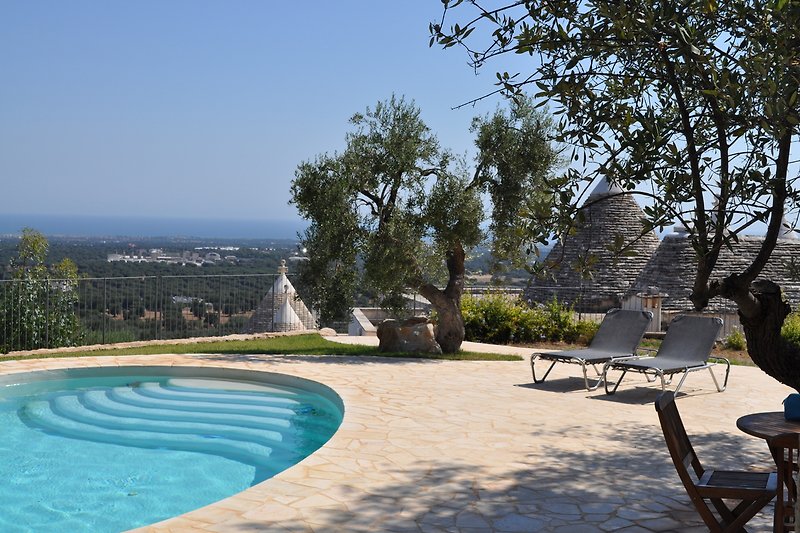 Relax by the poolside with views towards the sea