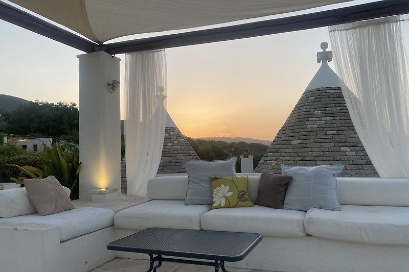Watch the sun set between the trullo cones in the stunning outside lounge