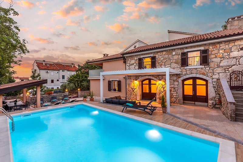 A stunning property with a heated pool and outdoor furniture.