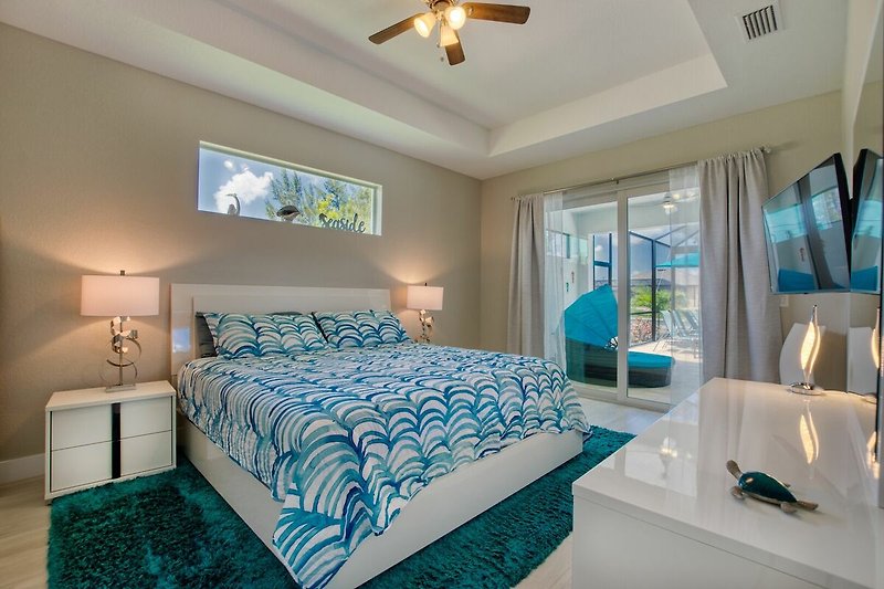 Stilvolles Schlafzimmer mit bequemem Bett und blauer Bettwäsche.