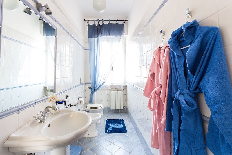 Un bagno elegante con specchio, lavandino e rubinetto in ceramica.