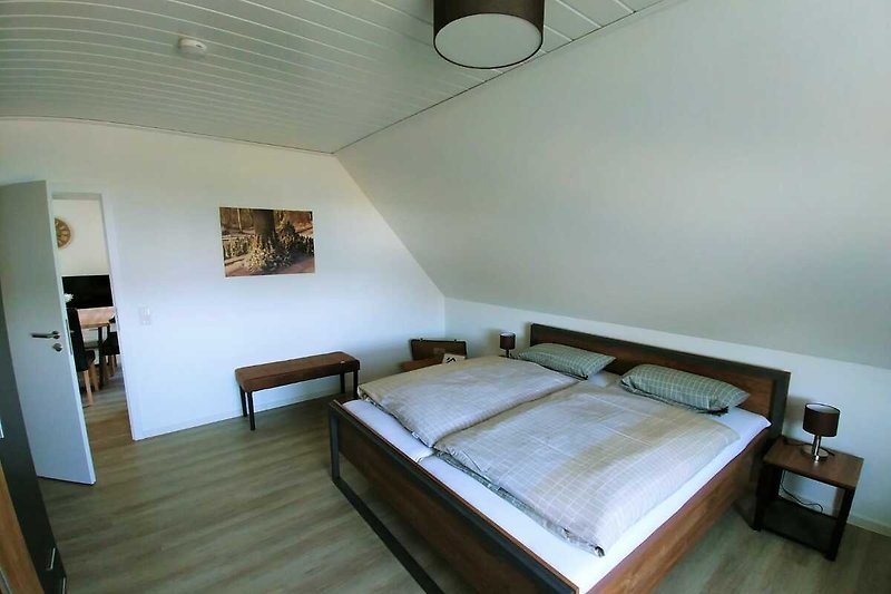 Gemütliches Schlafzimmer mit stilvollem Holzmobiliar und angenehmer Beleuchtung.