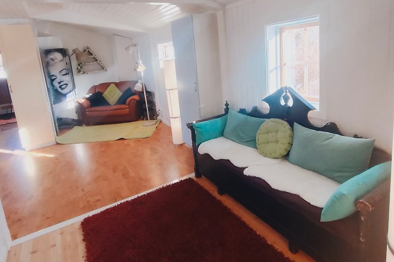 Gemütliches Schlafzimmer mit bequemem Bett, stilvoller Einrichtung und Holzboden.