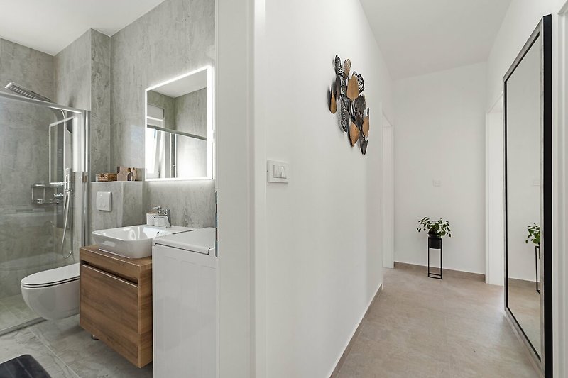 A modern bathroom with a sleek grey sink and elegant fixtures.