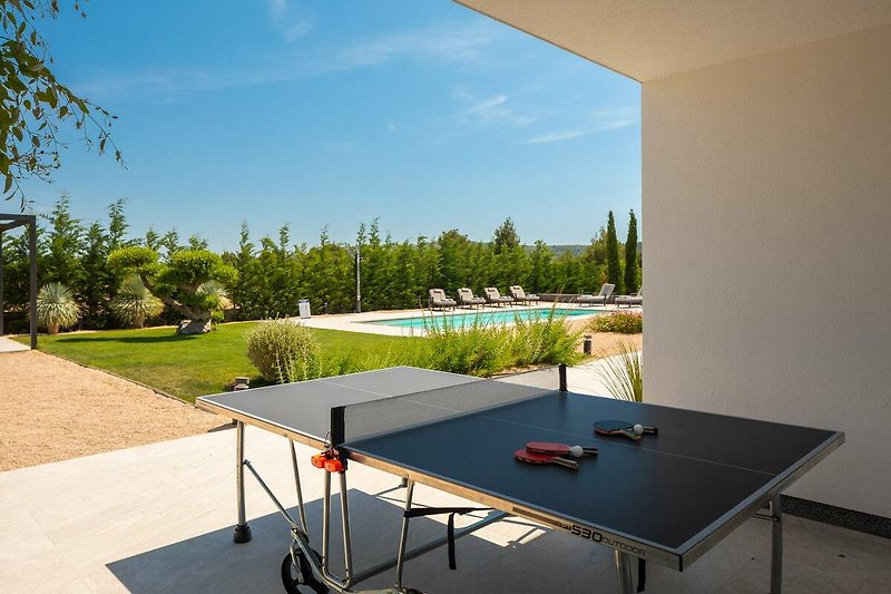 A modern property with stylish furniture and a beautiful outdoor setting.