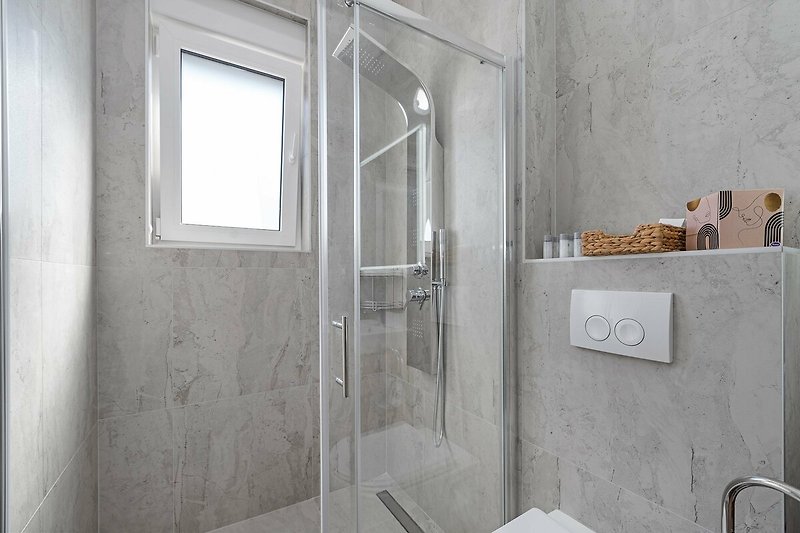A modern bathroom with sleek fixtures and a glass shower door.