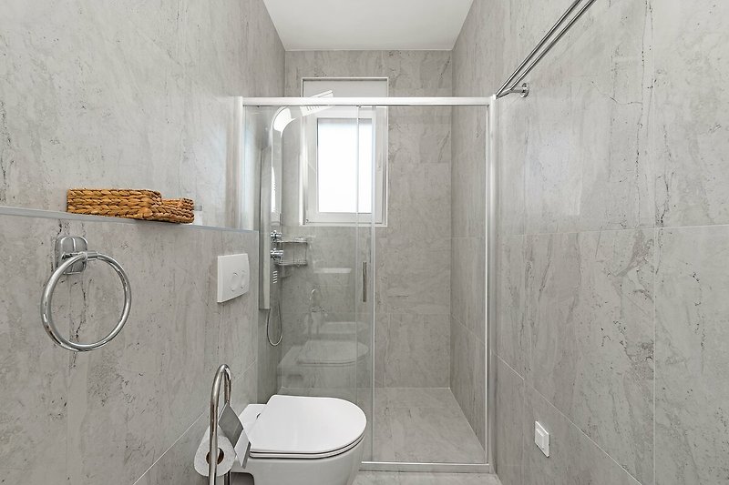 A modern bathroom with sleek fixtures and elegant design.