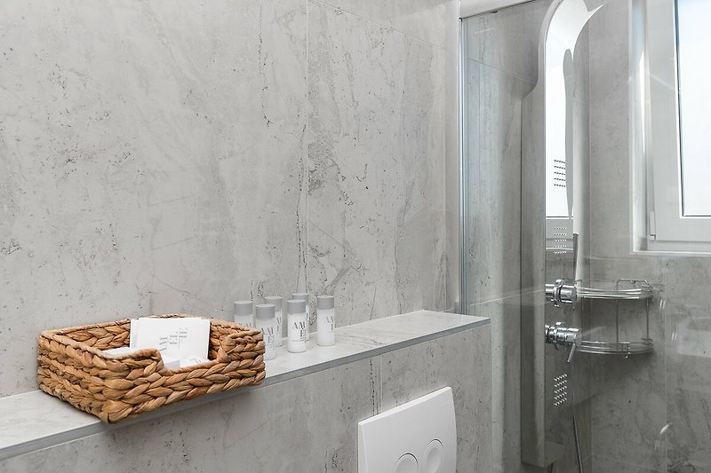 A modern bathroom with a sleek grey sink and elegant fixtures.