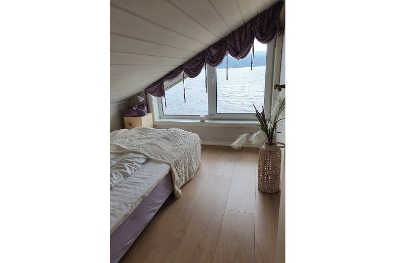 Stylish wooden bedroom with comfortable bedding and natural light. (160 cm under the roof)