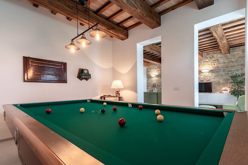Luxurious billiard room with elegant furniture and sports equipment.
