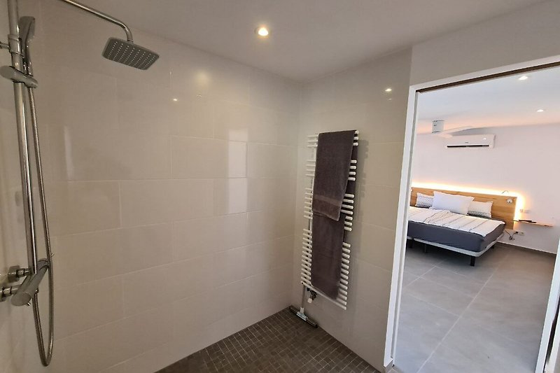 Bathroom with large shower and towel heater