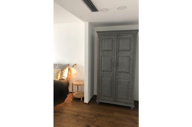 Bedroom no. 1 with a large stylish wooden wardrobe