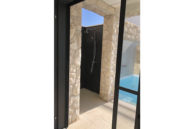 An outside shower by the pool