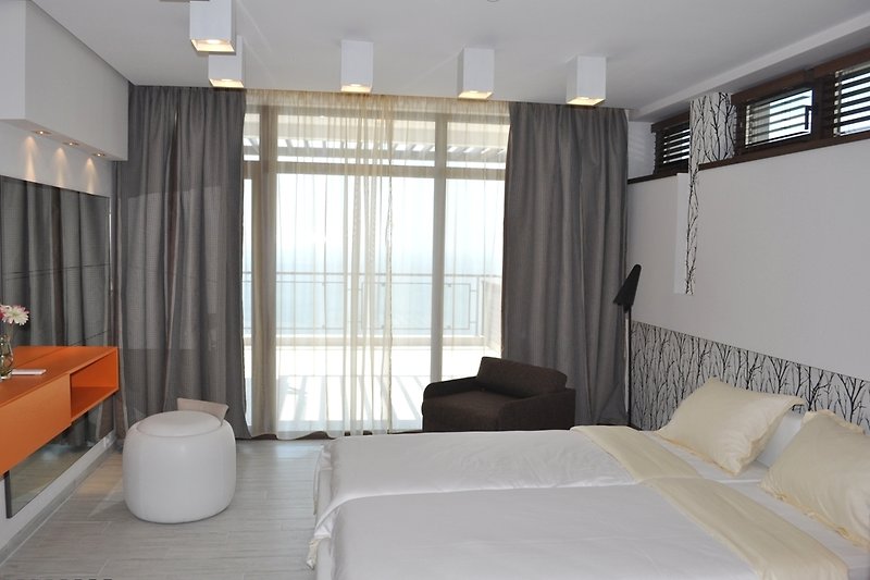 The elegant twin bedroom with an access to a balcony