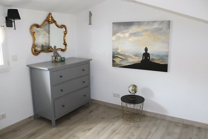 Ein stilvolles Schlafzimmer in der Galerie mit Holzmöbeln, Yoga und Meditation