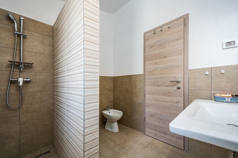 Schönes Badezimmer mit lila Badewanne und Holzboden.