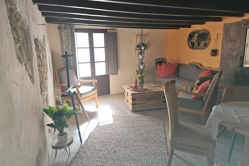 Wohnzimmer mit Holzboden, gemütlicher Couch und Lampenschirm.