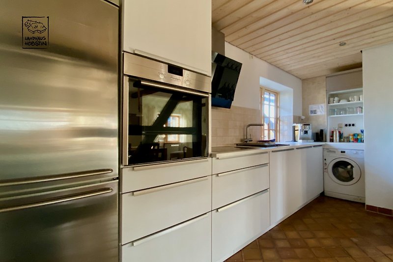 Die perfekt ausgestattete Küche mit, Filterarmatur,  Induktion, Umluft Herd, Spül- und Waschmaschine.