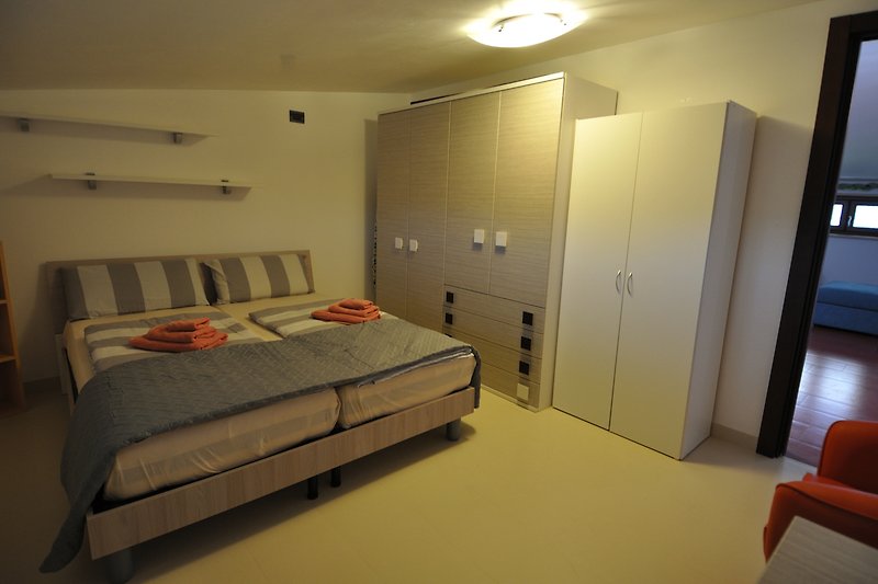 Stilvolles Schlafzimmer  2  mit gemütlichem Bett und eleganten Möbeln.