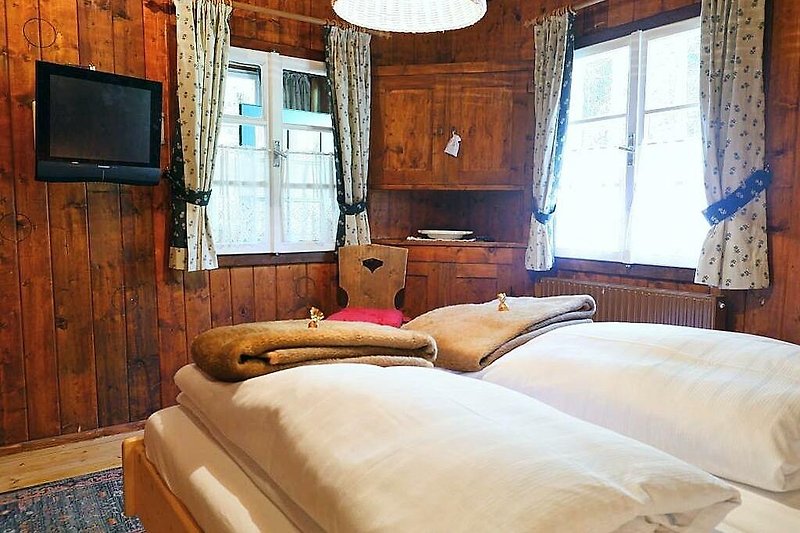Gemütliches Holzhaus mit stilvoller Einrichtung und bequemem Bett.