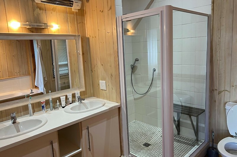 Modern bathroom with a sleek shower panel and elegant fixtures.