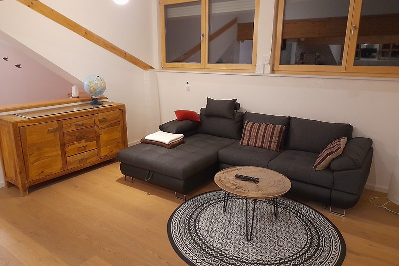 Gemütliches Wohnzimmer mit braunem Holzmöbel und stilvoller Beleuchtung.