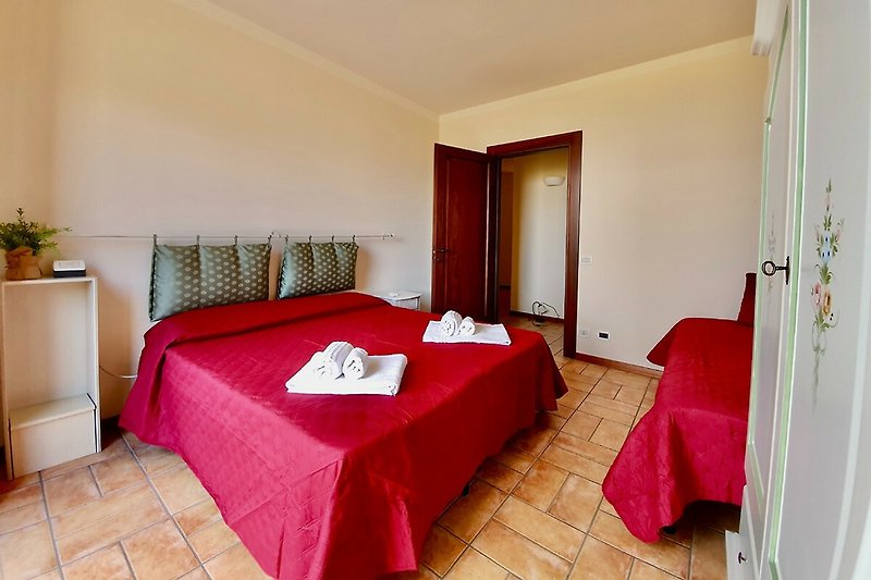 Una camera da letto accogliente con arredamento in legno e tessuti colorati.