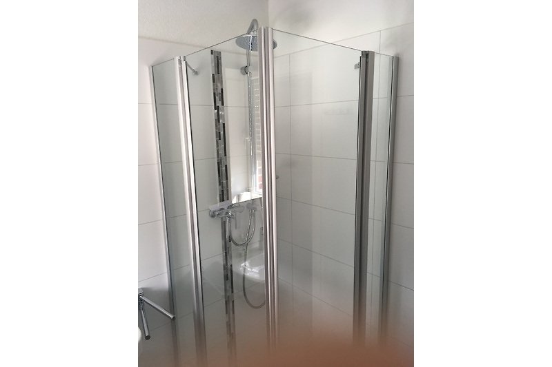 Zwei Moderne Badezimmern mit Glasduschen.