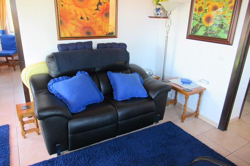 A stylish living room with comfortable furniture and a blue couch.