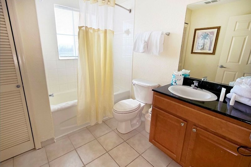 Experience the comfort and elegance of this stylish bathroom with a modern sink, mirror, and sleek fixtures.