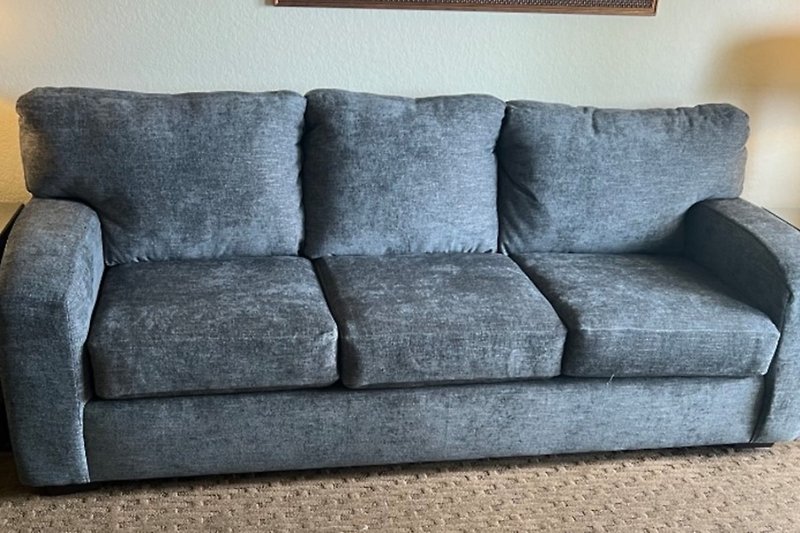 Experience the comfort of this updated couch, perfect for relaxing in this cozy living room.