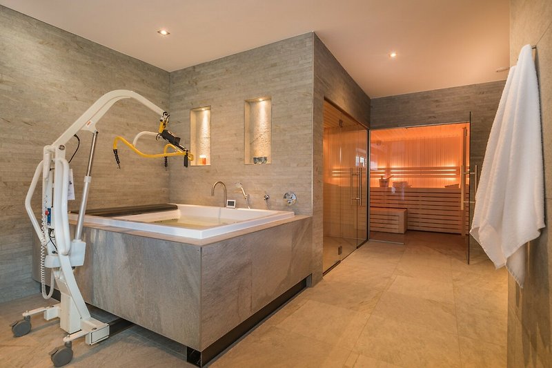 Ein modernes Badezimmer mit Holzboden, Waschbecken und Spiegel.